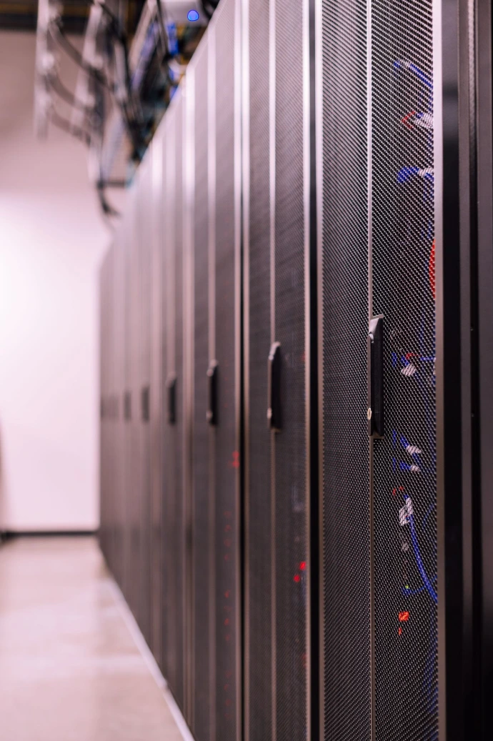 Modern server room aisle with structured data center server racks.